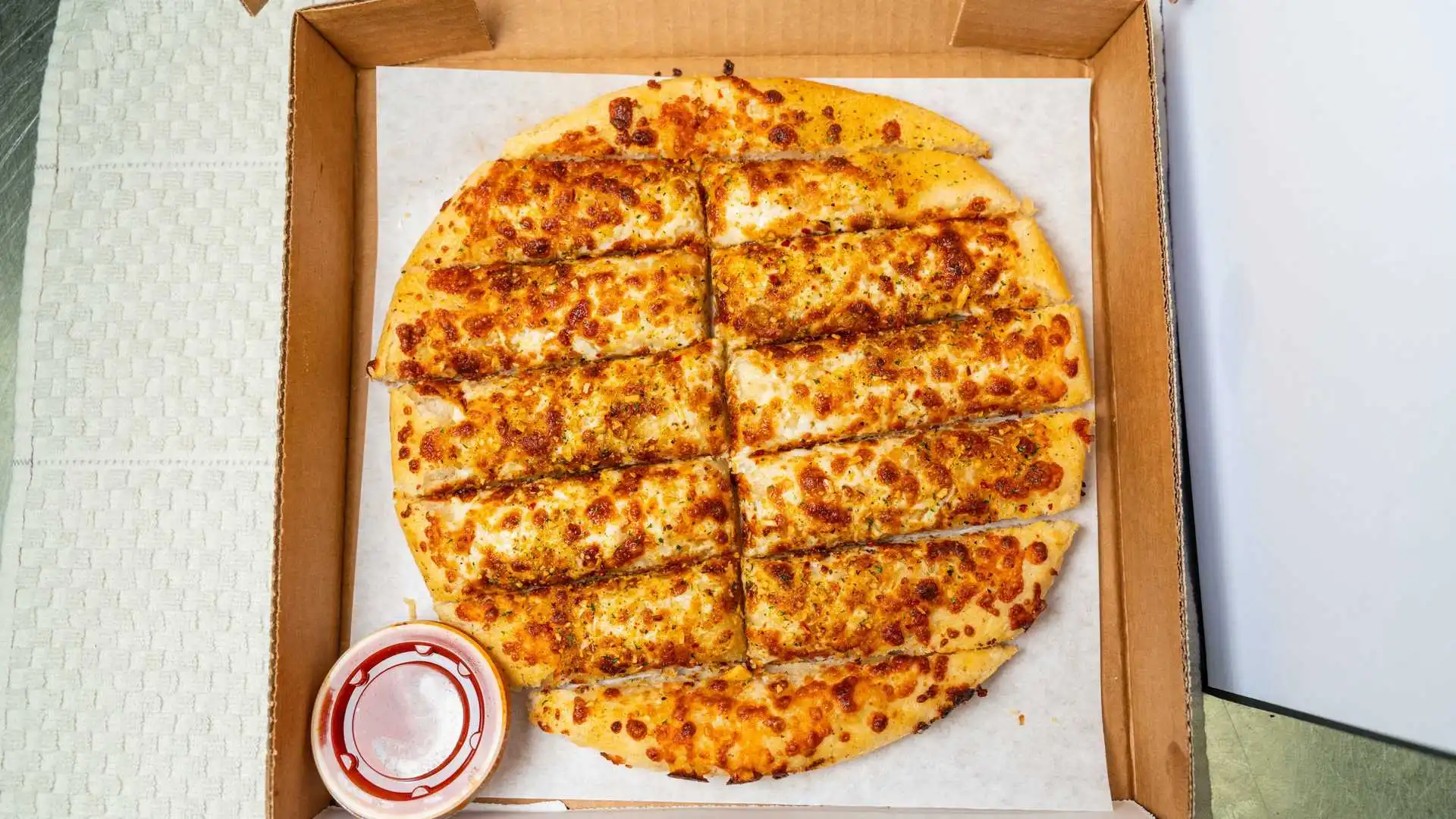 Garlic Butter Bread Sticks - Fresh baked breadsticks with garlic butter at Boss Pizza Edmonton